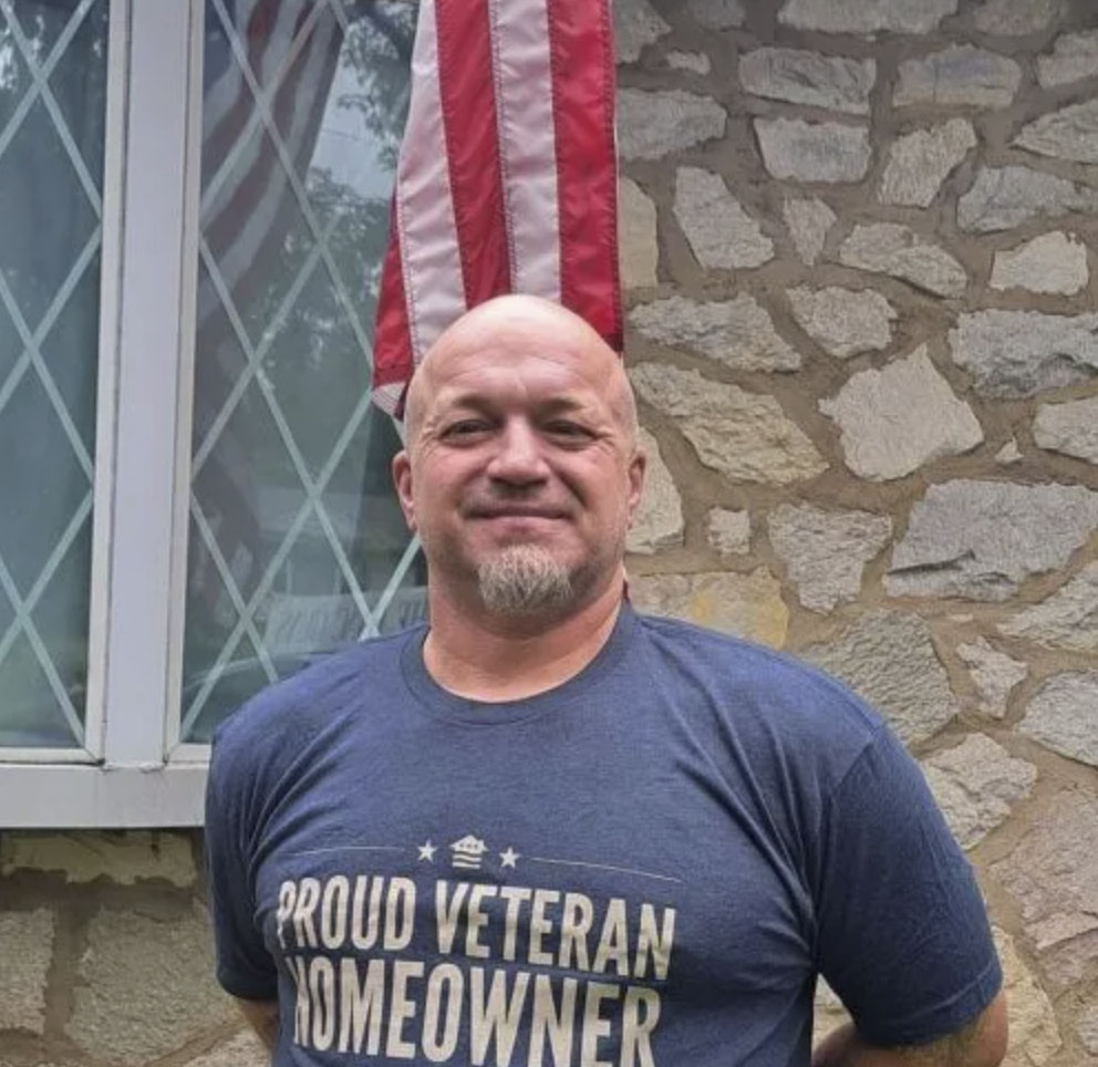 picture of William E. in front of a house
