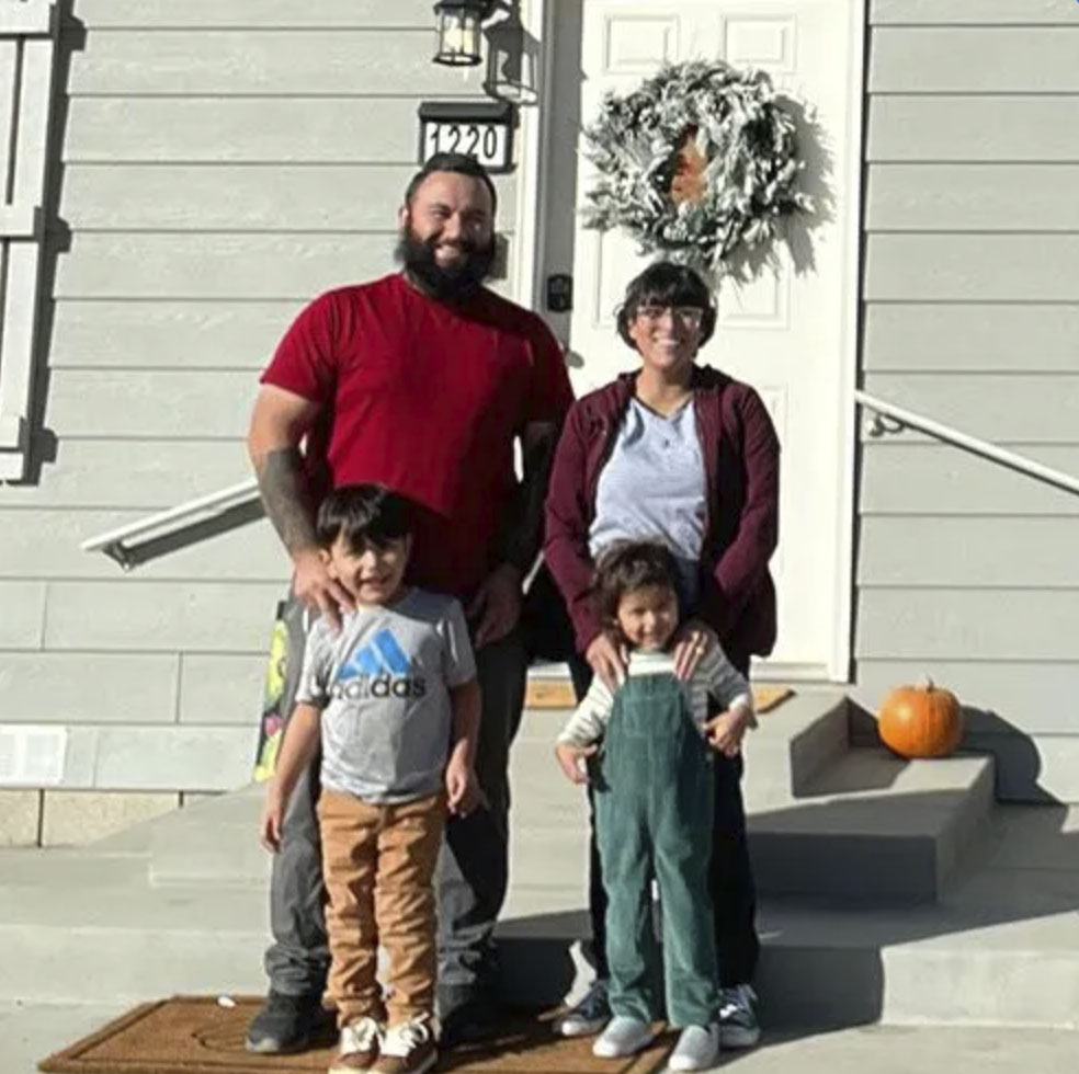 picture of Kevin C. in front of a house